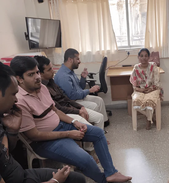 Small group seated together during a discussion and guidance session for visually impaired support.