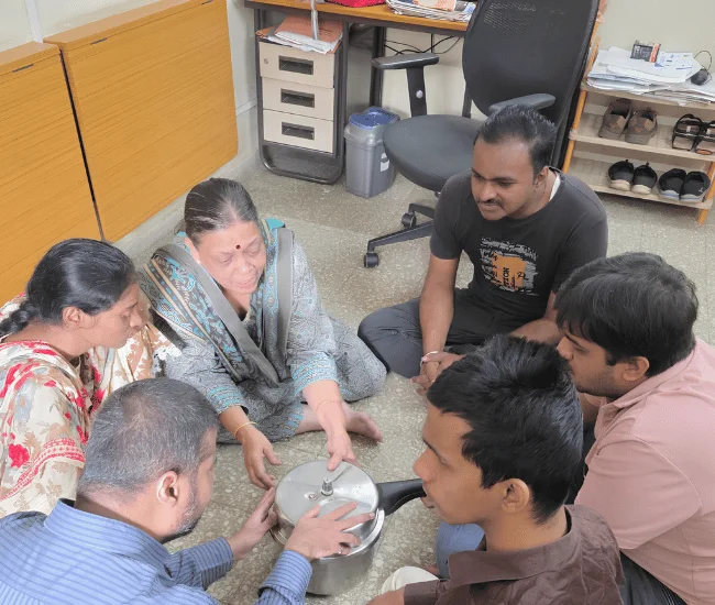 Volunteer helping an elderly person during a seated counselling or support interaction.