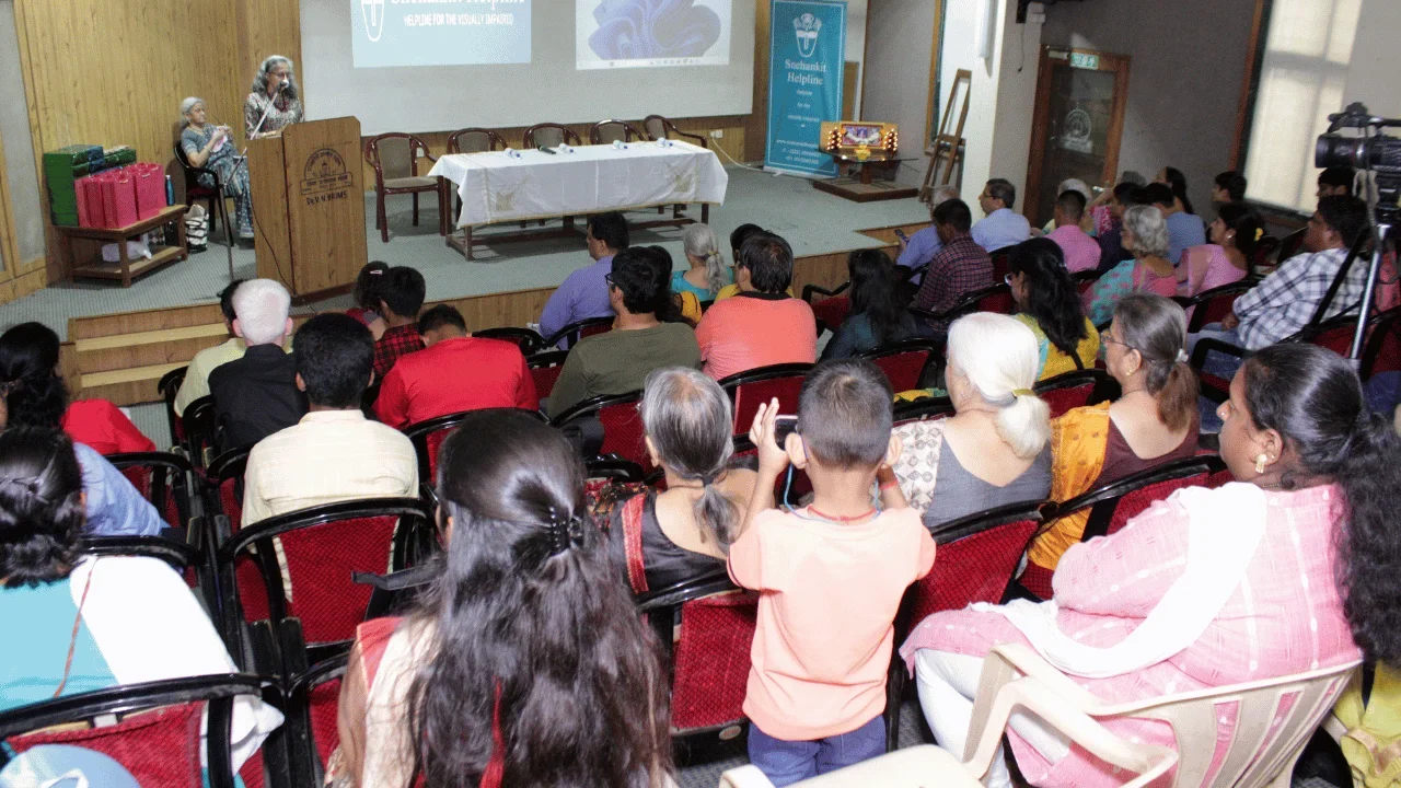Audience listening to a presentation during a Snehankit Helpline awareness session.